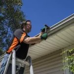 depositphotos_84767202-stock-photo-worker-repairing-a-gutter-on